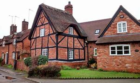 Exterior view of brick and timber cottages
