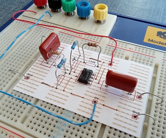 Electronic breadboard with Op-Amp and various resistors and capacitors.