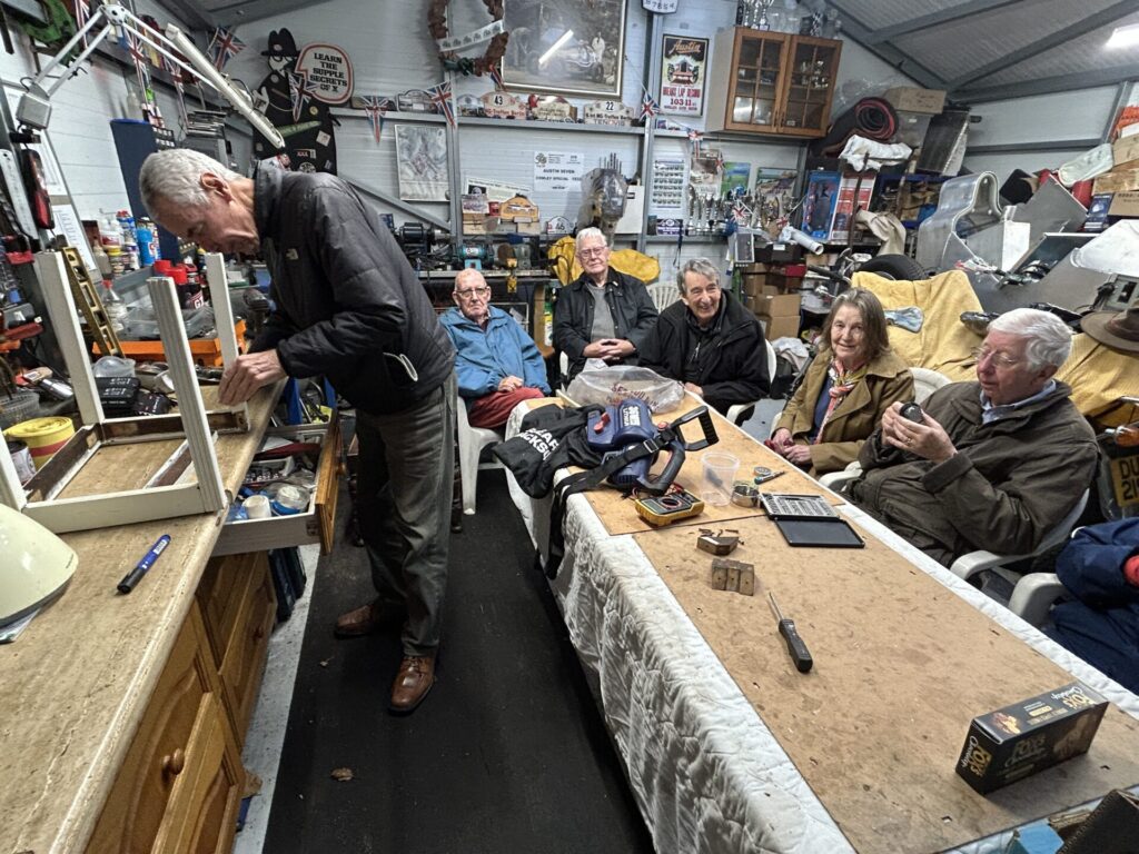 Anita happy once the behaviour of the Lithium batteries on her cordless leaf blower is properly understood by everyone. Menmawjile Geff glues up the wobbly legs on the stool from Jeanine's 'Boudoir'.