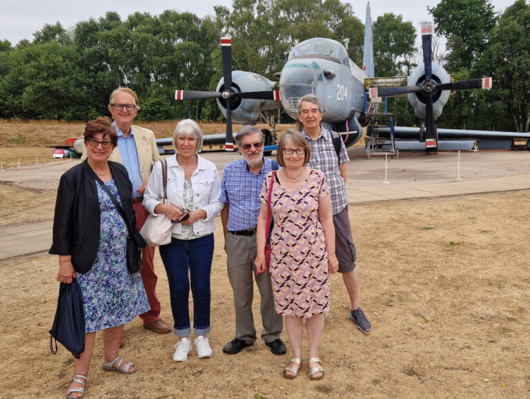 Science Group members standing in front of an old plane, one of the outdoor exhibits at RAF Cosford Museum